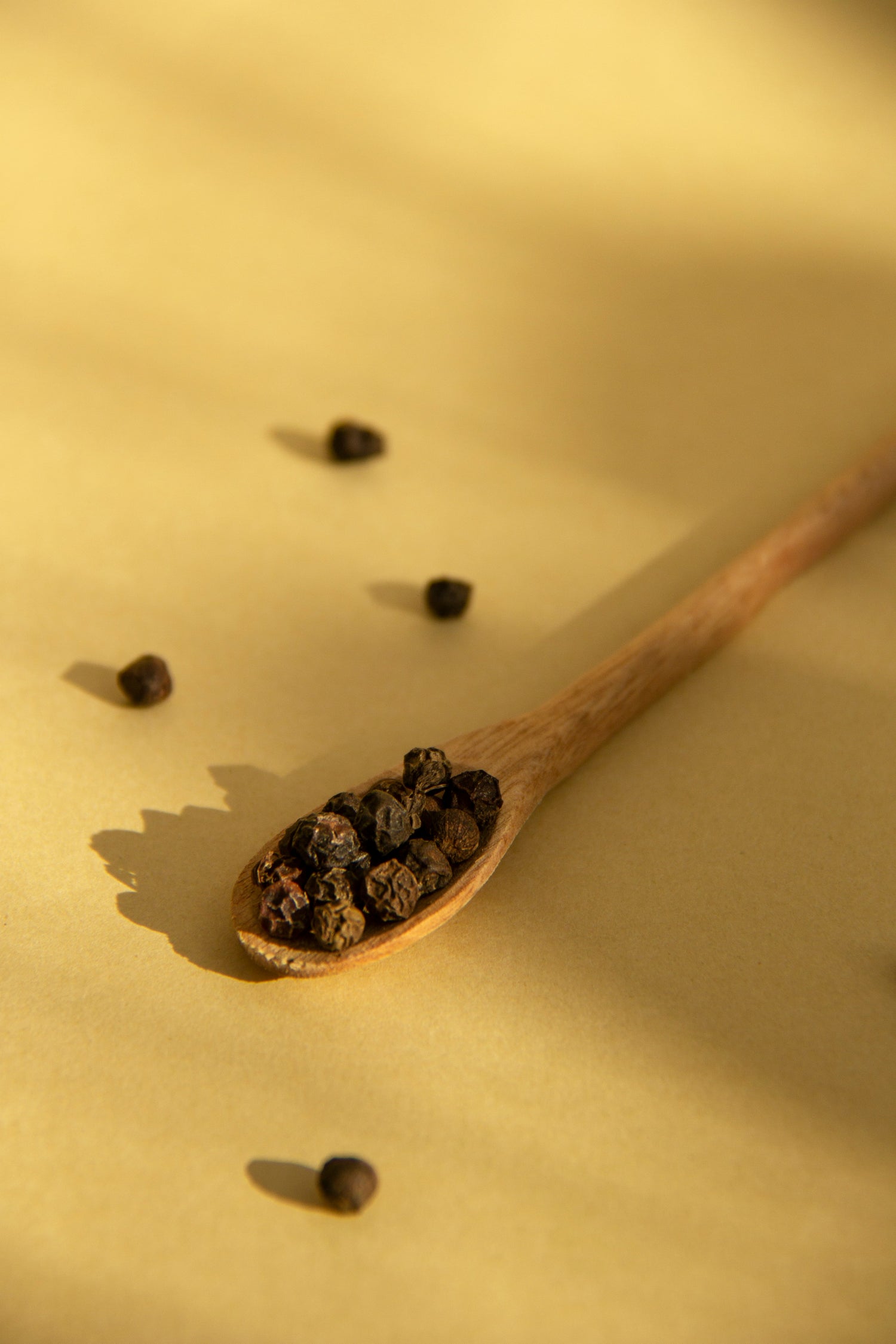 Glass jar of lamb rub seasoning blend with visible herbs and spices, labeled and set on a wooden surface